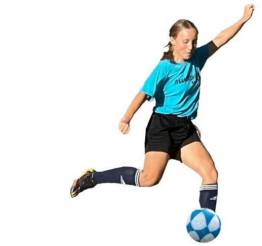 A girl kicking around a soccer ball on the field.